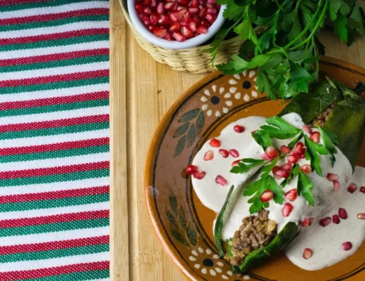 high-angle-shot-chiles-en-nogada-plate-wooden-board-table_gm_optimized high-angle-shot-chiles-en-nogada-plate-wooden-board-table_gm_optimized